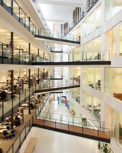The atrium of the Manchester Institute of Biotechnology with walkways crossing between offices.
