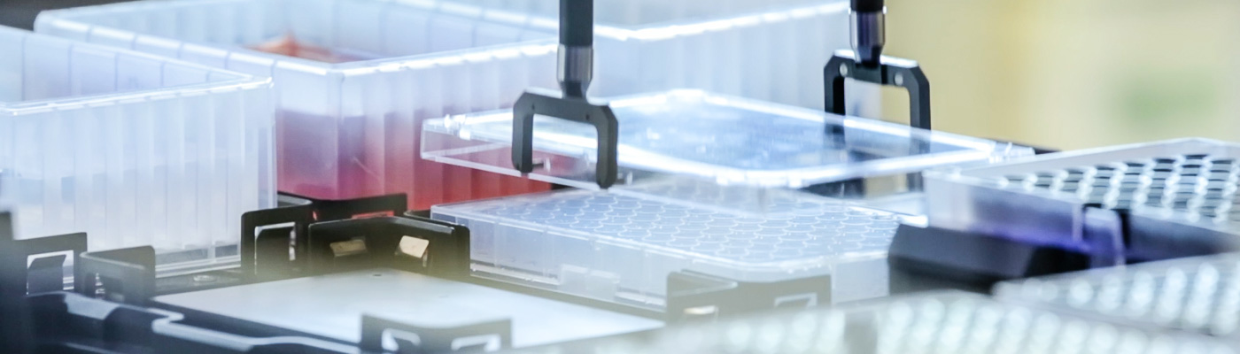 A machine picks up a tray of liquid samples.